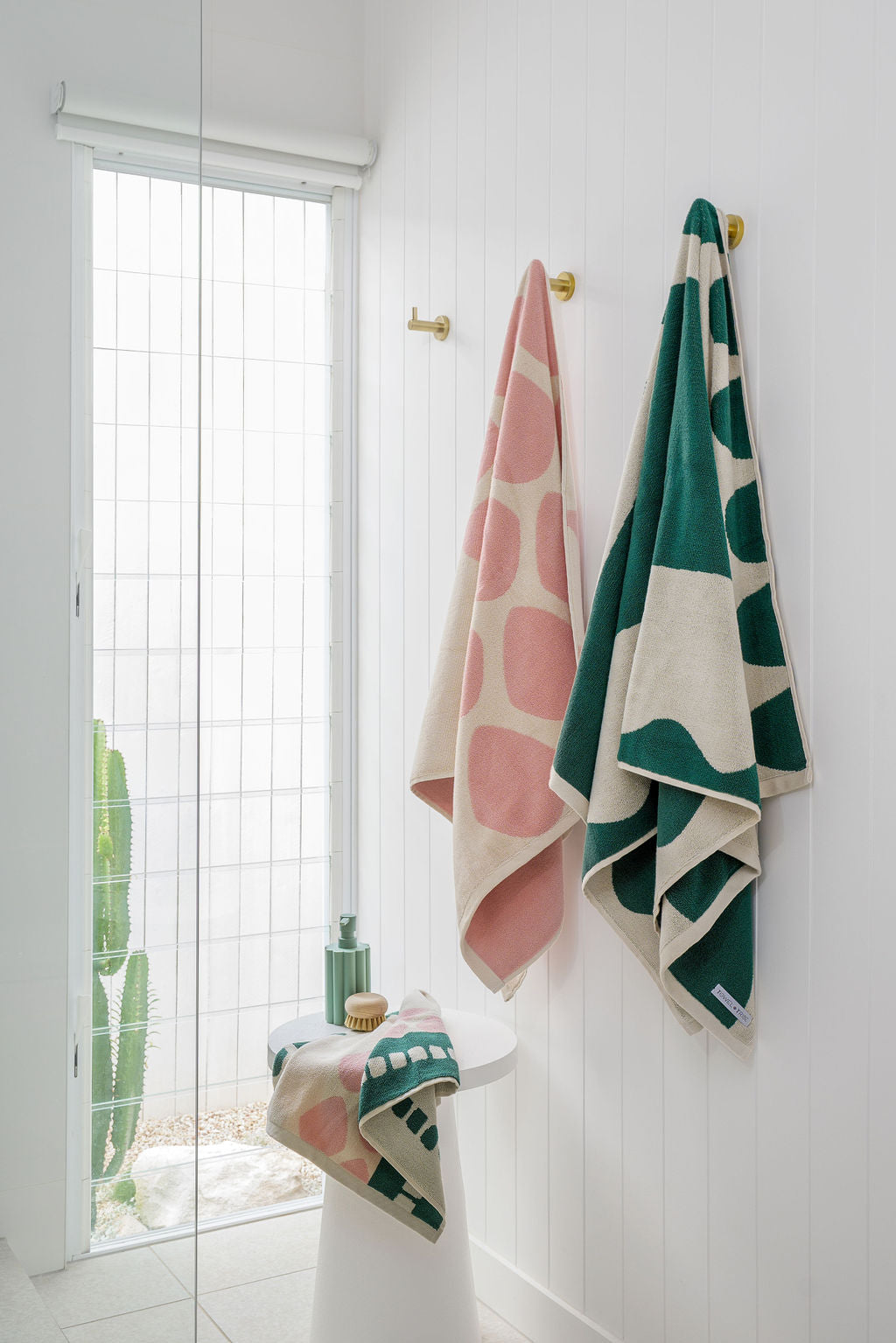 Luxury green and pink towels hanging 